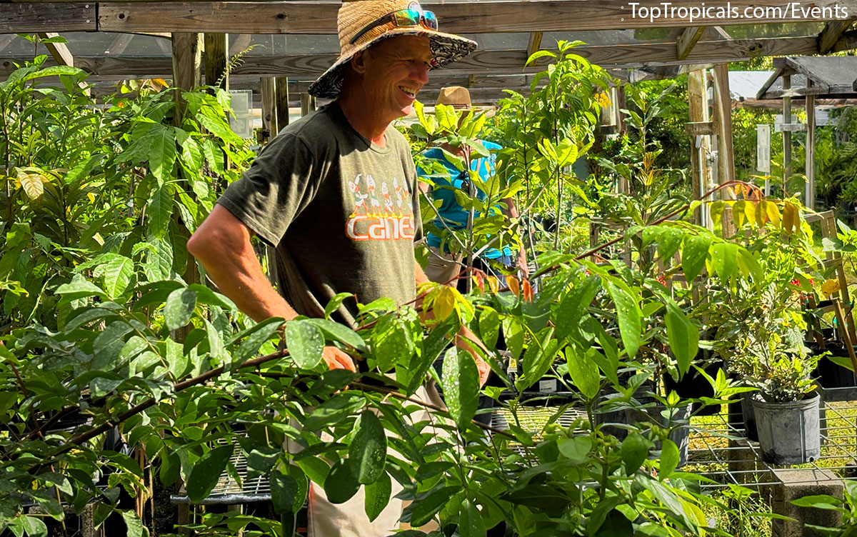 Smiling vistors looking at  tropical plants at Top Tropicals Fathers Day Plant Market